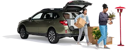 A mother and daughter remove household items from their SUV.